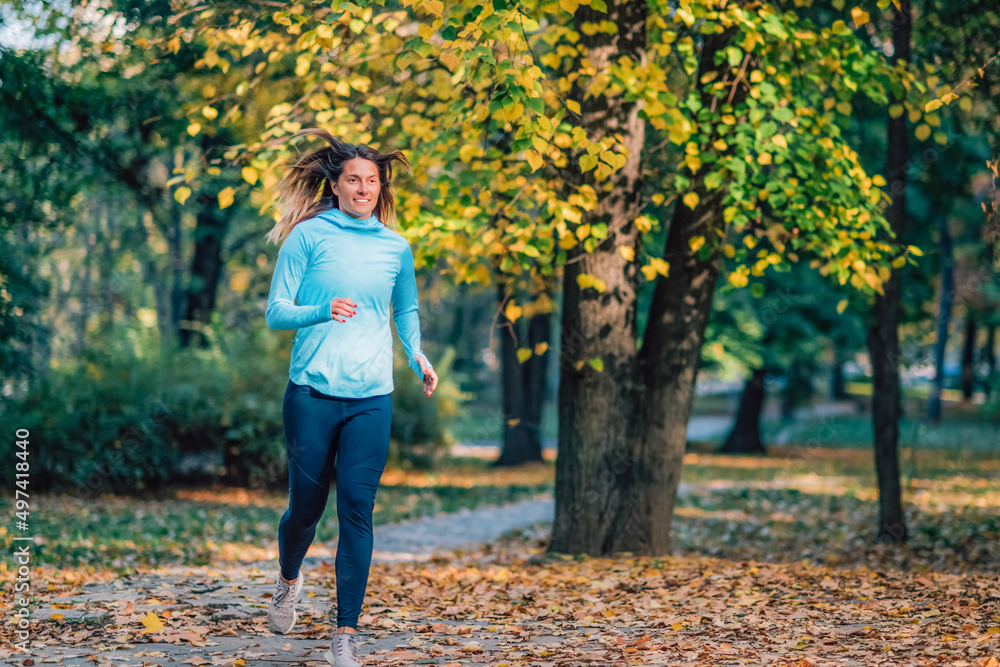 Woman Running in Public Park in the Fall. Woman Running in Public Park in the Fall.