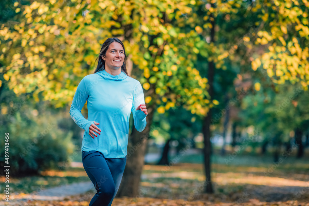 Woman Running in Public Park in the Fall. Woman Running in Public Park in the Fall.