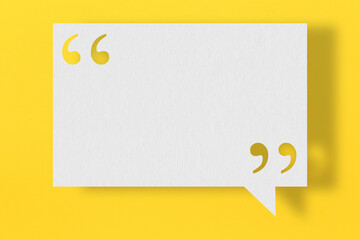 Empty white note paper floating on yellow art paper background.