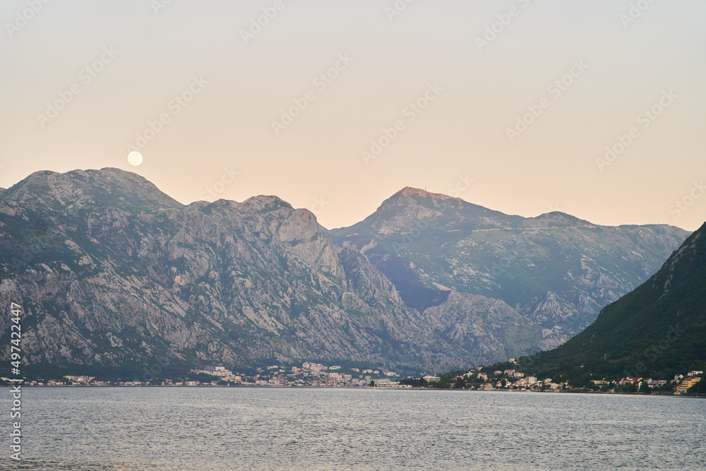 View of the sunset in Boko-Kotor Bay in Montenegro. Silhouettes of mountains. High quality photo
