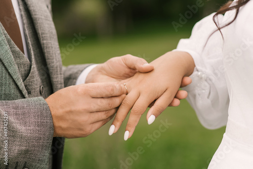 The bride and groom exchange wedding rings, close-up © ksyusha_yanovich