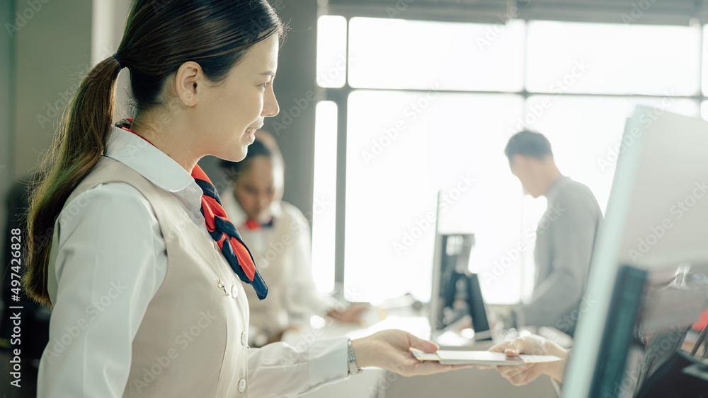 Closeup Flight attendant woman or Air hostess in uniform checking seats boarding pass and passport on the airplane before flight traveling. Closeup Flight attendant woman or Air hostess in uniform checking seats boarding pass and passport on the airplane before flight traveling.