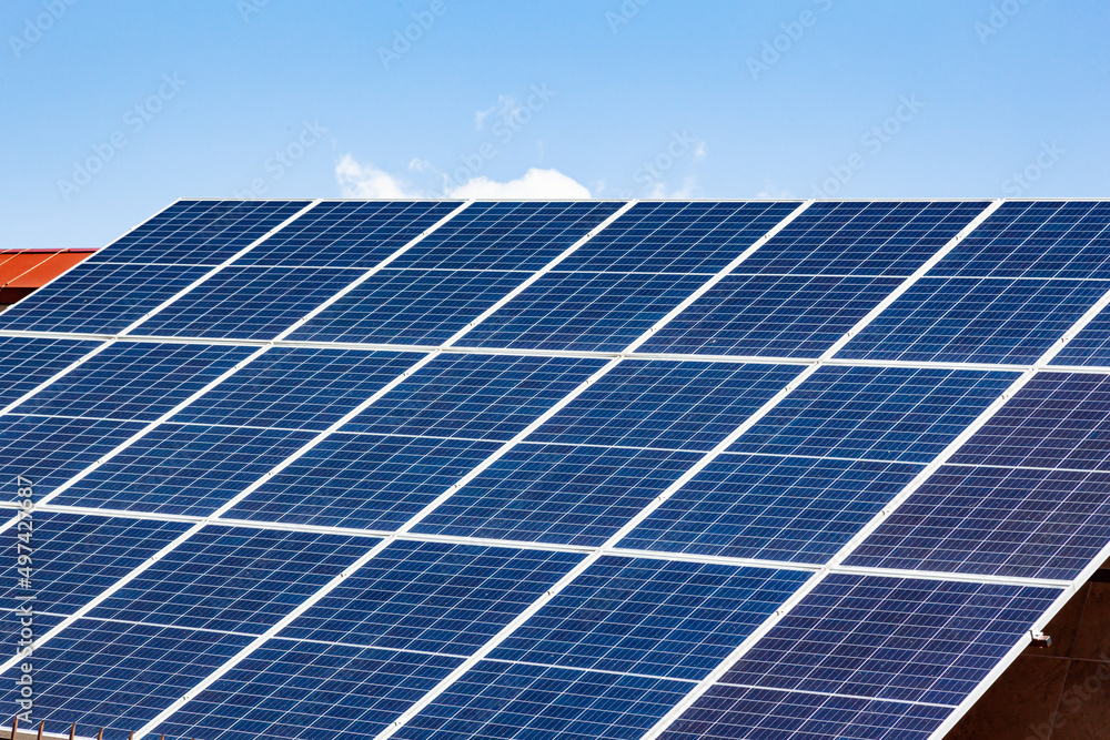 Solar panels on the roof of a house close-up. The solar panels are stacked close to each other. Solar panels on the roof of a house close-up. The solar panels are stacked close to each other.