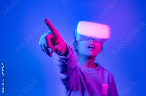 Girl wearing virtual reality goggles, Future technology concept, finger touching the screen