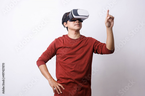 Asian man in casual style using Virtual Reality glasses make movement, studio shot, mock up branding and copy space for creative advertisement designer