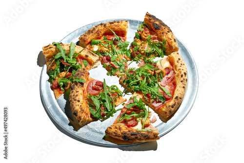 Sliced Pizza with salami, sausage and arugula isolated on a white background
