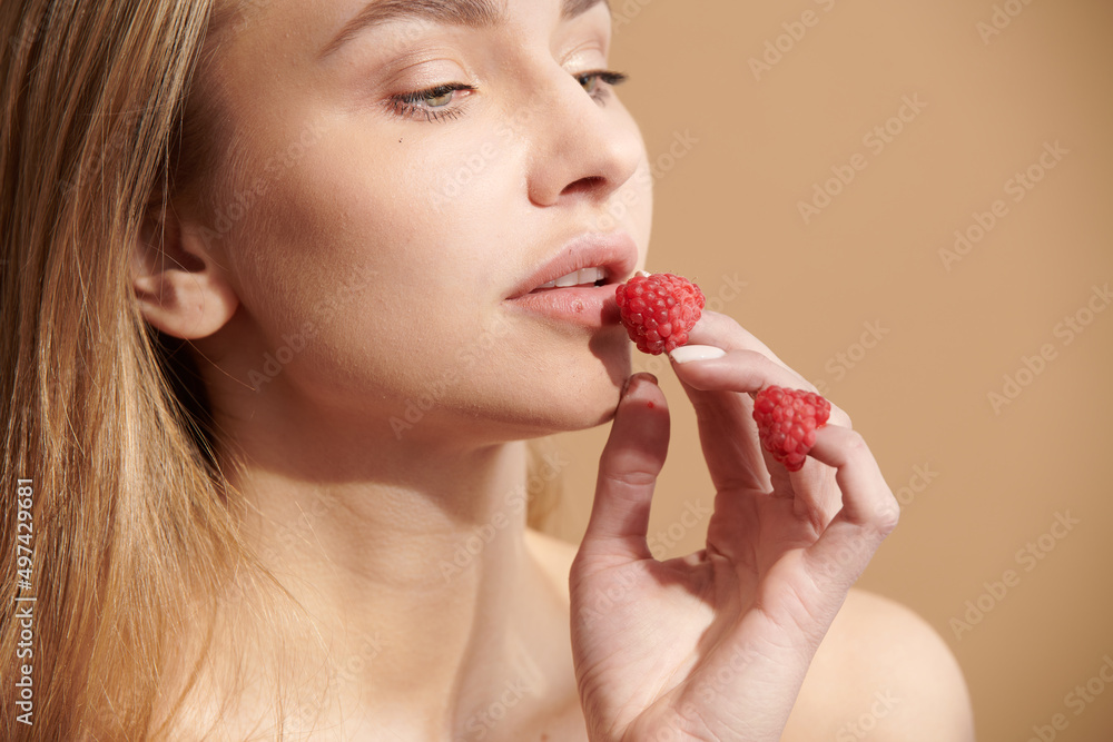 Young happy girl with fresh strawberries
