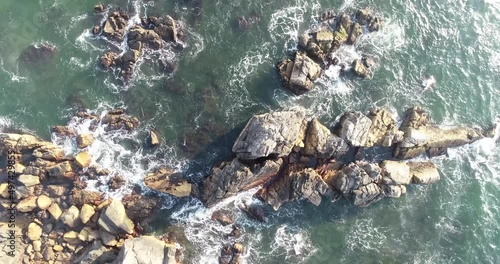 Sea waves breaking over rocks aerial view 