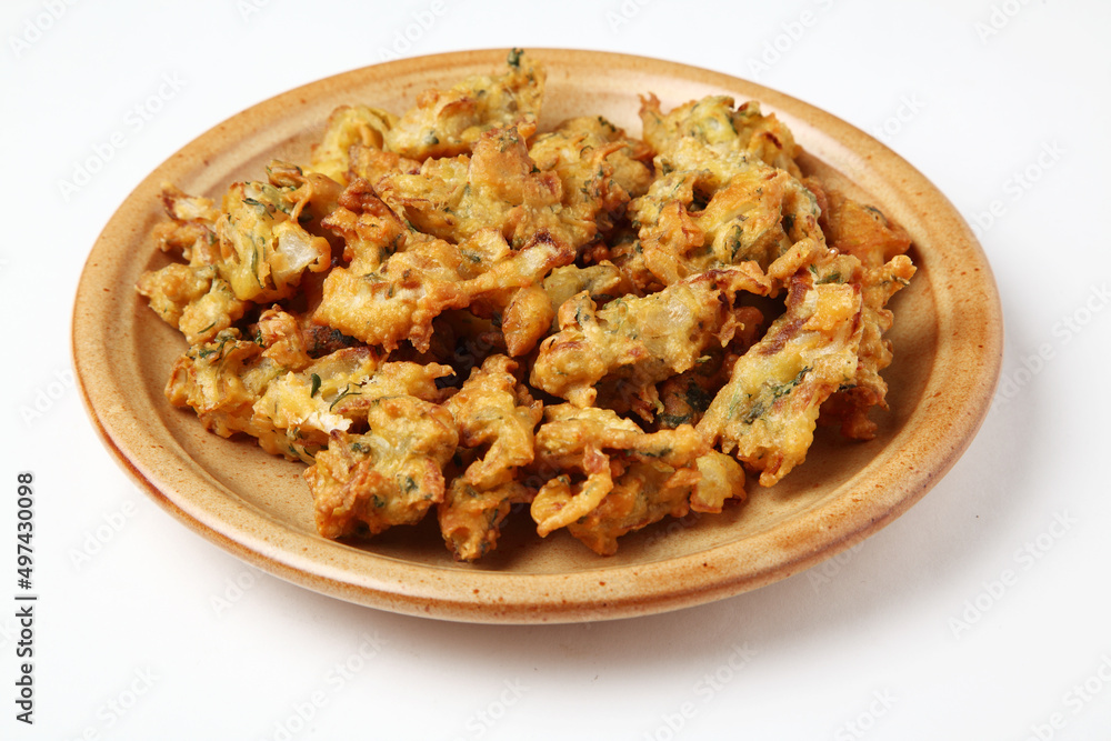 Fried onion pakora or Pyaj Pakoda also known as Crispy Kanda bhaji /Bhajji / bajji, favourite Indian Tea-Time snack during the rainy season. served with tomato ketchup Fried onion pakora or Pyaj Pakoda also known as Crispy Kanda bhaji /Bhajji / bajji, favourite Indian Tea-Time snack during the rainy season. served with tomato ketchup