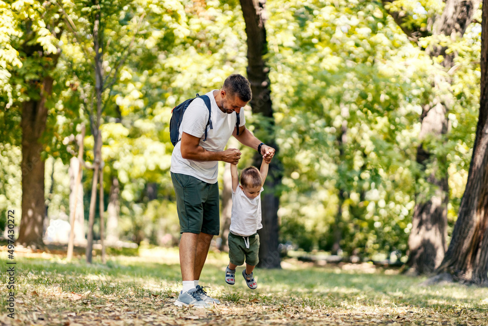 A father lifting son and playing games with him in nature. A father lifting son and playing games with him in nature.