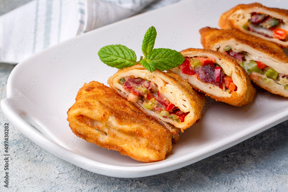 Turkish Pacanga Boregi with pastirma (pastrami) and cheddar (melted) cheese. - Pastirmali Borek Turkish Pacanga Boregi with pastirma (pastrami) and cheddar (melted) cheese. - Pastirmali Borek