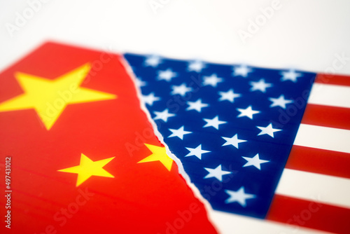 Torn flag of America and Chinese flag