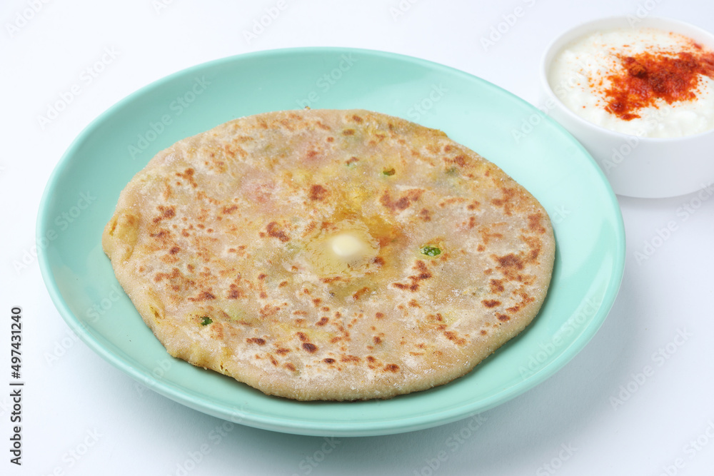 Traditional Indian food Aloo paratha or potato stuffed flat bread. served with curd Traditional Indian food Aloo paratha or potato stuffed flat bread. served with curd