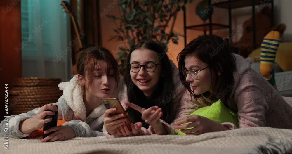 Female Friends Having Fun Together At Home Party. Yonung woman in funny onesies at pajama party. Female Friends Having Fun Together At Home Party. Yonung woman in funny onesies at pajama party.