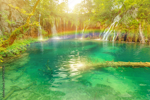 Rainbow on the and jetty of Galovacki Buk waterfall of Plitvice Lakes National Park in Croatia in the Lika region. UNESCO World Heritage of Croatia named Plitvicka Jezera. © bennymarty