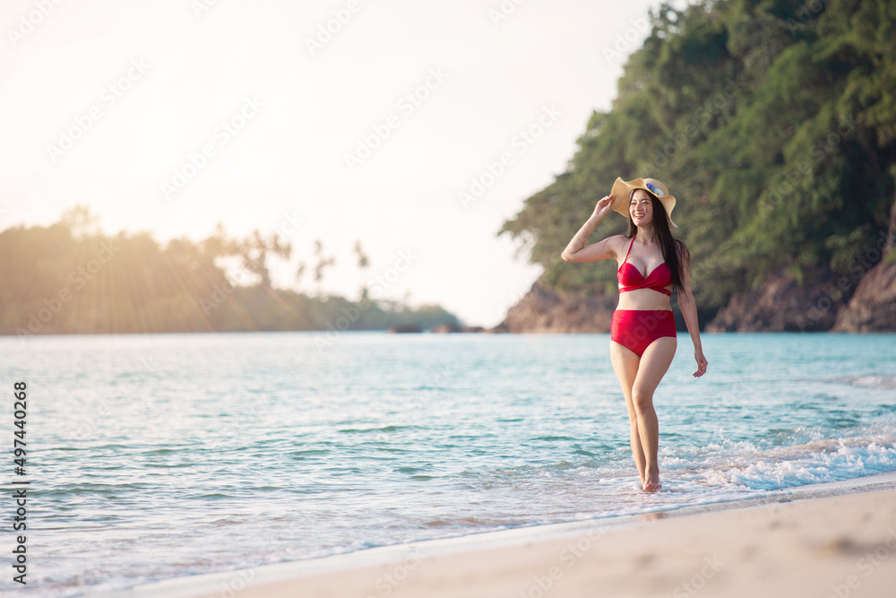 Young beauty asian woman in dress happy travel smile walk on beach sea near blue water wave for trip vacation. Summer day tan skin girl happy in red bikini smiling at sunbath on koh chang, Thailand. Young beauty asian woman in dress happy travel smile walk on beach sea near blue water wave for trip vacation. Summer day tan skin girl happy in red bikini smiling at sunbath on koh chang, Thailand.