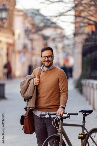 Portrait of cheerful caucasian man, riding a bike, thinking about the environment.