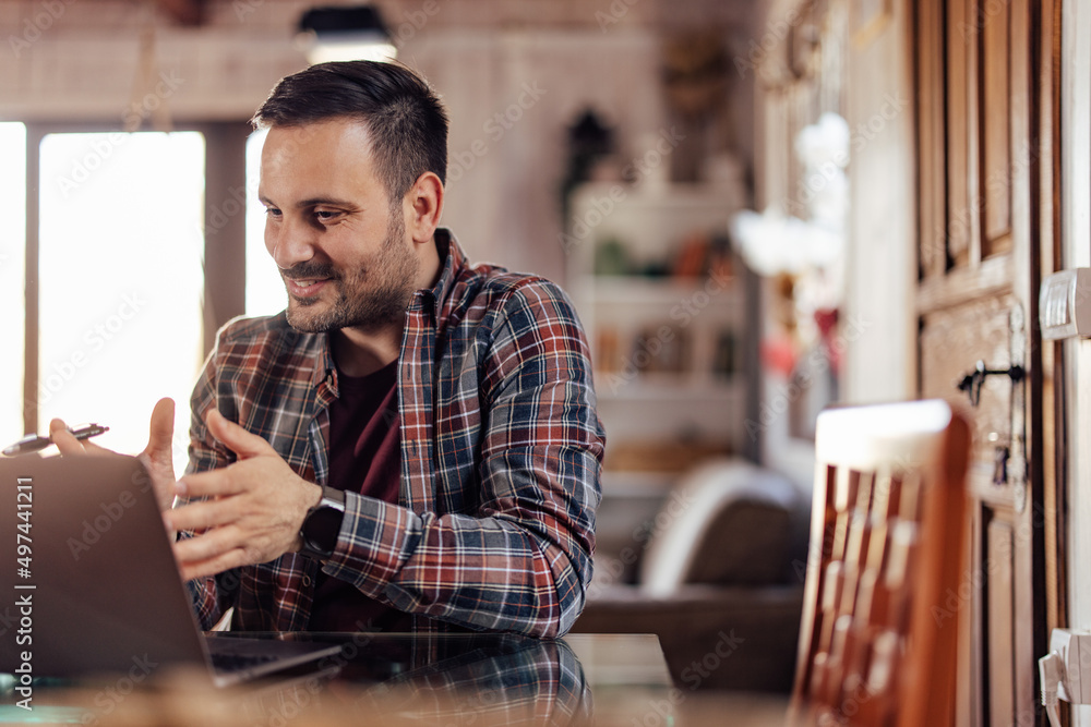 Focused man having an online meeting, talking to his clients. Focused man having an online meeting, talking to his clients.