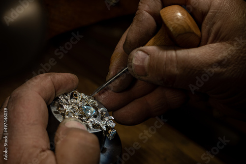 Different goldsmiths tools on the jewelry workplace. Jeweler at work in jewelry. Desktop for craft jewelry making with professional tools. Close up view of tools.