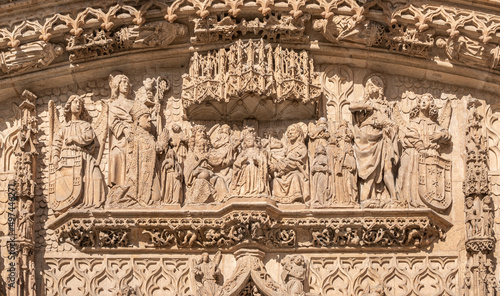 Primer plano de la escena de coronación de la Virgen, en presencia de fray Alonso de Burgos arrodillado en la fachada iglesia san Pablo de Valladolid, España photo