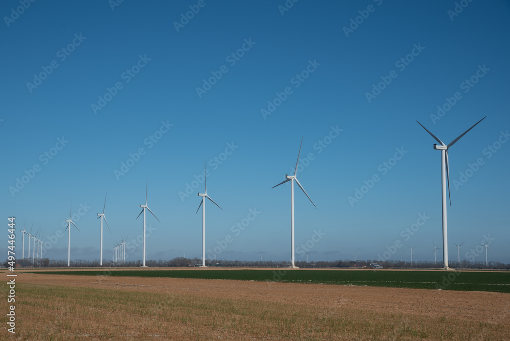 North Holland, Netherlands, March 2022. Wind turbines in the polder landscape of North Holland. North Holland, Netherlands, March 2022. Wind turbines in the polder landscape of North Holland.