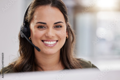 You know who to call when you need the right advice. Portrait of a young call centre agent working in an office.
