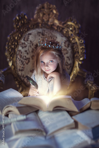 Canvastavla A magical portrait of a girl with a crown, writing in a magic book with a crow's feather