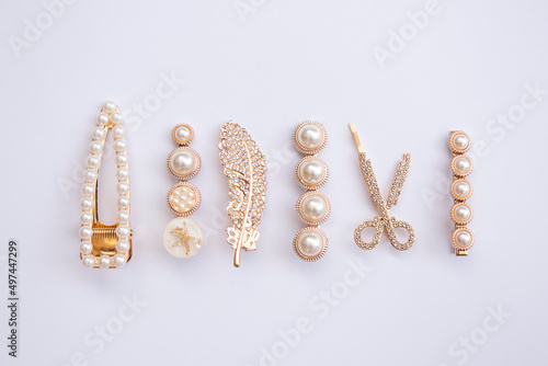 pattern of hair clips with pearls on white background