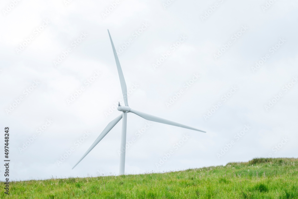 Scottish landscape with clouds, windmills, and sheep Scottish landscape with clouds, windmills, and sheep