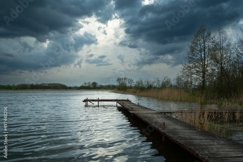 Wooden pier in a lake and cloudy sky, Stankow, Poland © darekb22