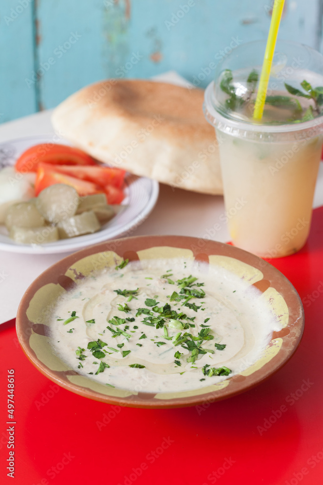 Hummus served with pita bread, vegetables and a cold beverage Hummus served with pita bread, vegetables and a cold beverage