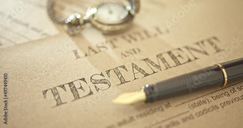 Last will and testament, legacy, inheritance or death tax concept : Fountain pen, a pocket watch on a last will and testament. A form is waiting to be filled and signed by a testator or testatrix.
