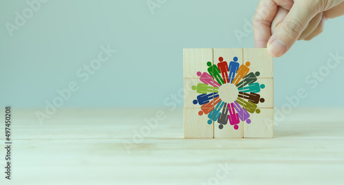 Team building and diversity concept. Work collaboration for achieving goal and successful business. Productive people skills. Hand placed wooden cubes with team diversity building icons. HRM Banner. photo