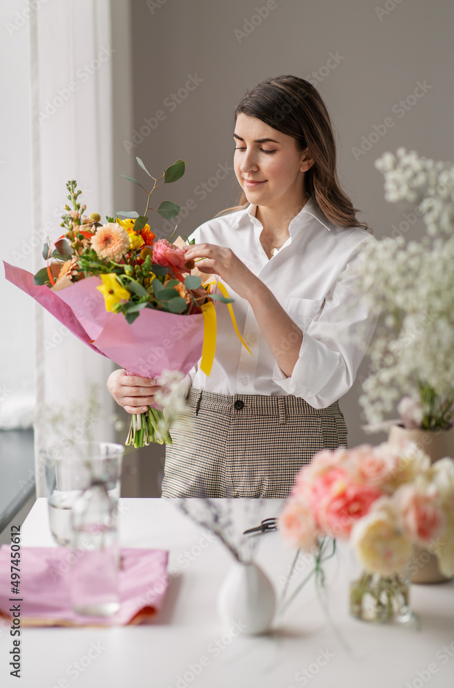 people, gardening and floral design concept - happy smiling woman or floral artist with bunch of flowers at home people, gardening and floral design concept - happy smiling woman or floral artist with bunch of flowers at home