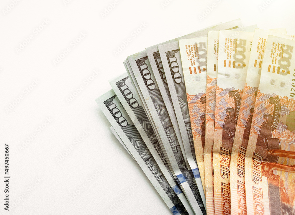 American dollars and Russian rubles on a white rectangular background. Exchange of national currency.Operations with money. American dollars and Russian rubles on a white rectangular background. Exchange of national currency.Operations with money.
