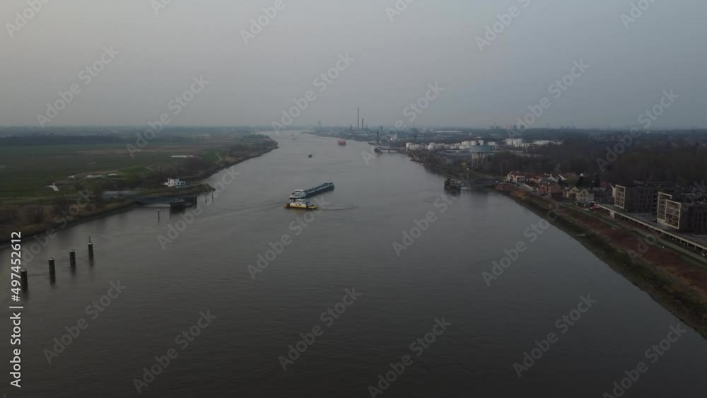 Two industrial transport boats passing each other on river Scheldt, aerial drone view Two industrial transport boats passing each other on river Scheldt, aerial drone view