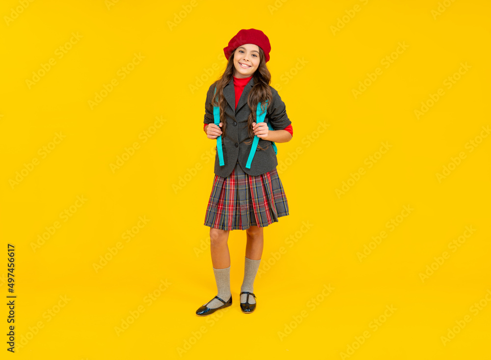cheerful teen girl in beret carry backpack. back to school. knowledge day. concept of education.