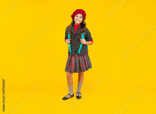 cheerful teen girl in beret carry backpack. back to school. knowledge day. concept of education.