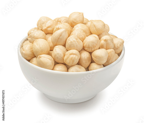 Bowl of peeled hazelnuts isolated on white background