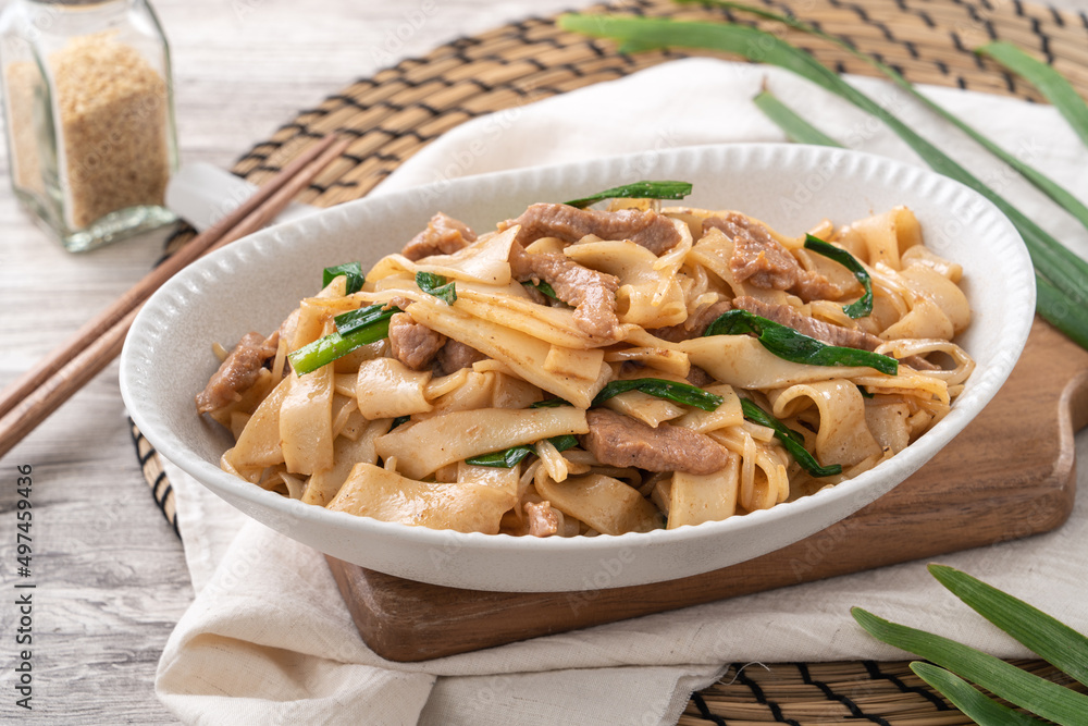 Delicious stir-fried Taiwanese Hakka flat rice noodles on white background. Delicious stir-fried Taiwanese Hakka flat rice noodles on white background.