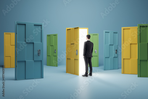 Quadro su tela Businessman standing in front of abstract colorful puzzle door in interior