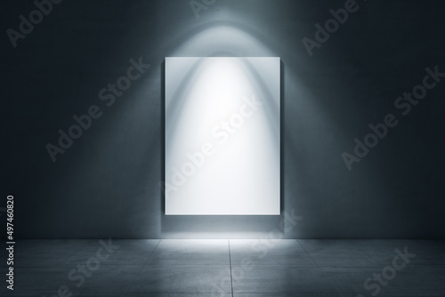 Illuminated white poster on dark concrete wall with mock up place. Grunge art gallery concept. 3D Rendering.