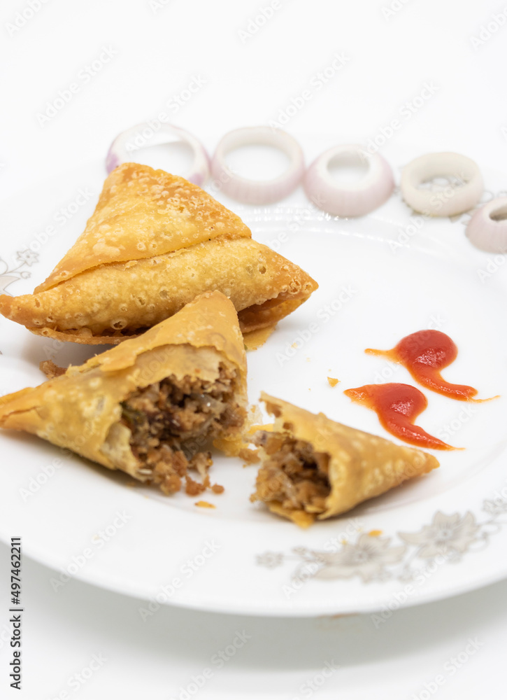 Samosa in a plate with chili and onion isolated on white background, Samosa in a plate with chili and onion isolated on white background,
