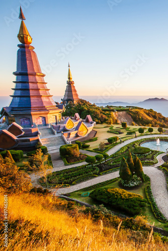 The scenery of two pagodas on the mountain during sunrise.