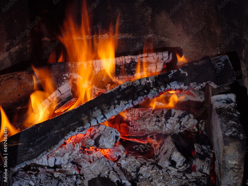 Flame of smoldering and burning coal in the fireplace Flame of smoldering and burning coal in the fireplace