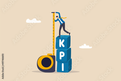 KPI, key performance indicator measurement to evaluate success or meet target, metric or data to review and improve business concept, businessman standing on top of KPI box measuring performance. photo
