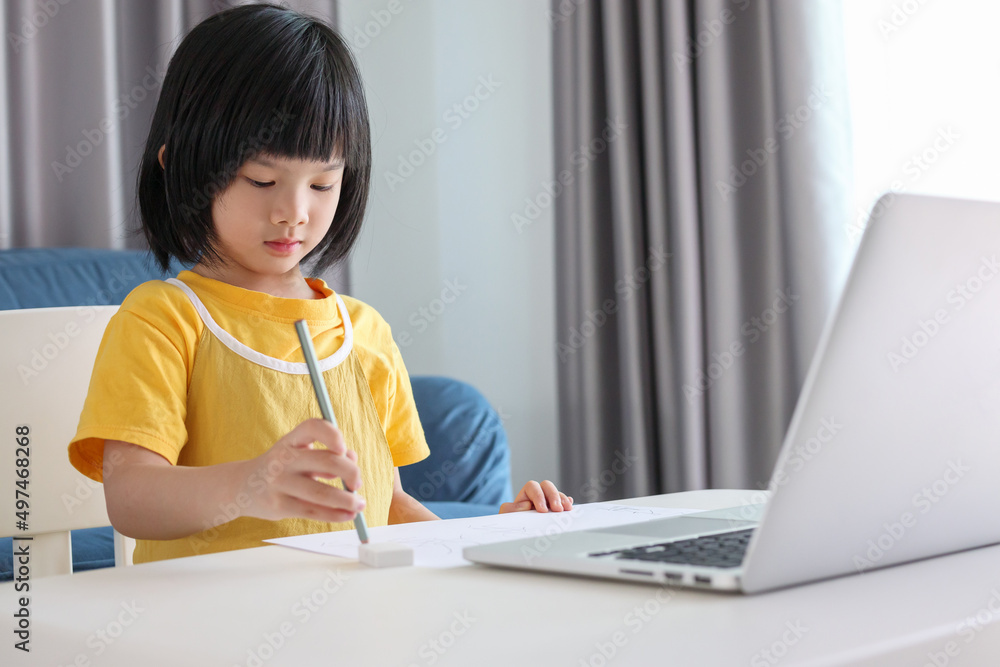 little asian girl student study online using laptop computer at home little asian girl student study online using laptop computer at home