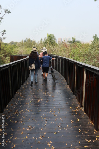 family spend leisure time walking on the wooden briage for relaxation concept photo