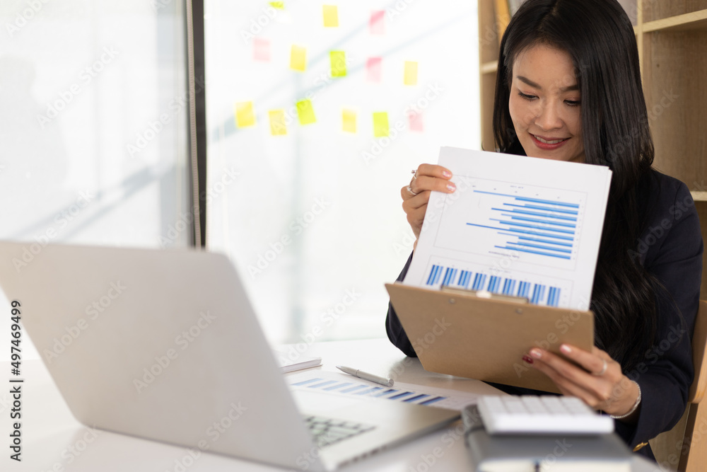 Business woman in the office working on the audit of business reports and auditing documents. Business woman in the office working on the audit of business reports and auditing documents.