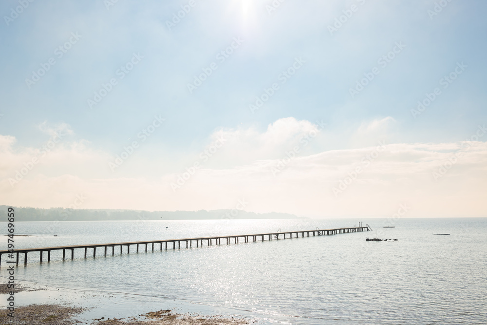 Long wooden pier protrudes into the lake